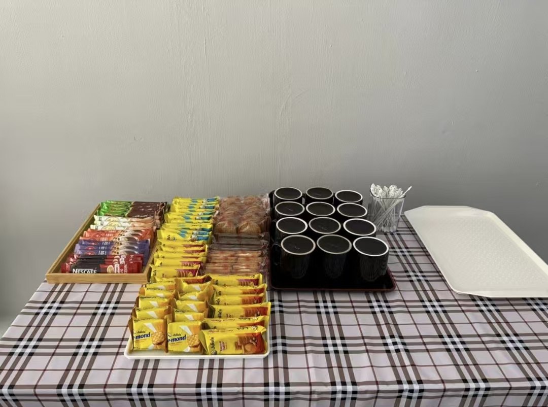 Coffee sachets, biscuits and mugs laid out on a table